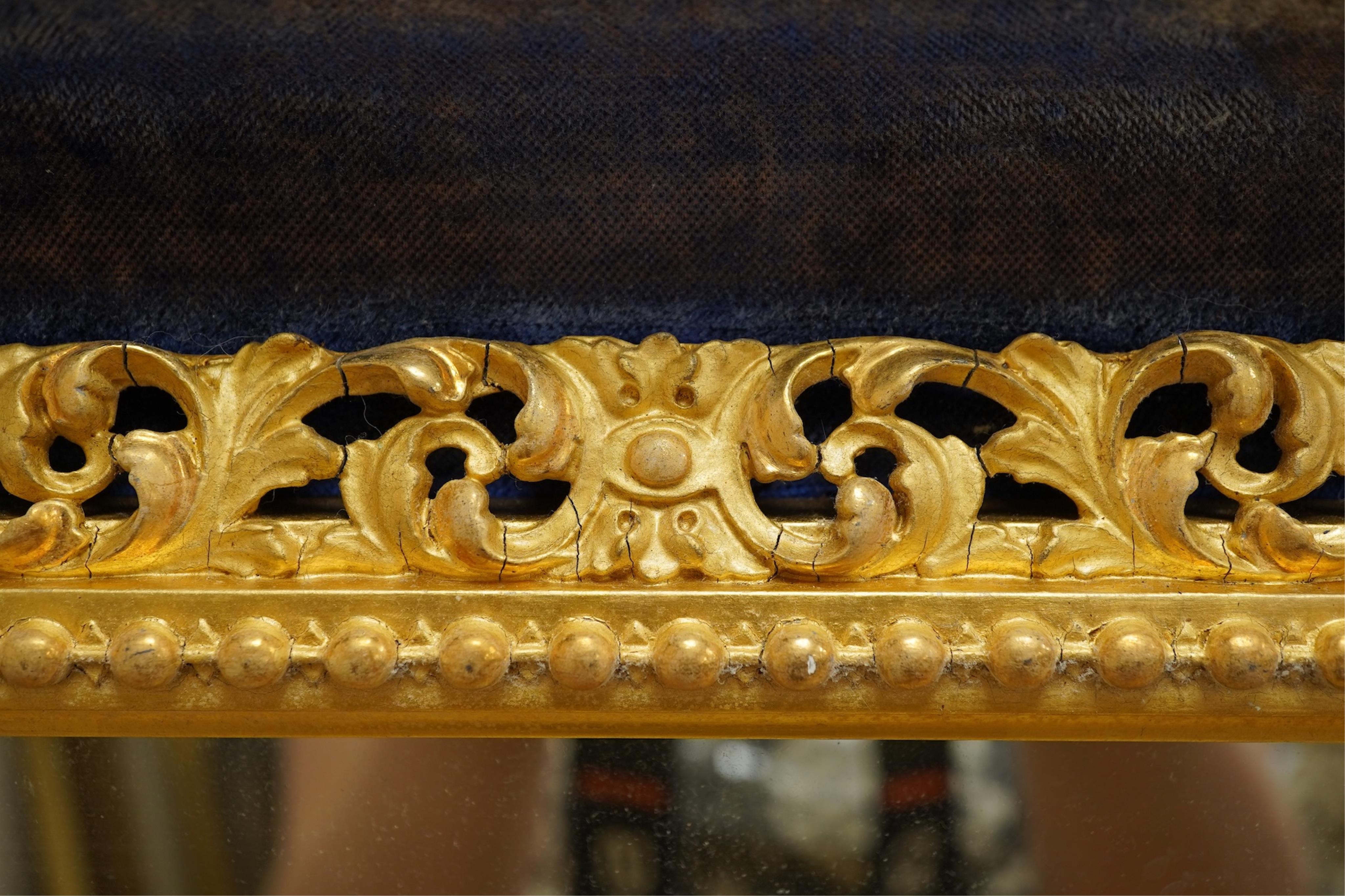 A 19th century carved gilt wood framed mirror, displayed within a blue velvet mount and outer rosewood frame, 48cm wide x 56cm high